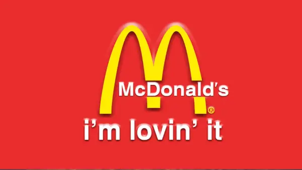 McDonald's "i'm lovin' it" - klasyczne hasła reklamowe przykłady. Złote łuki na czerwonym tle.